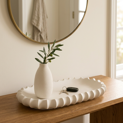 Ivory fluted tray styled with keys and a vase on an entryway console