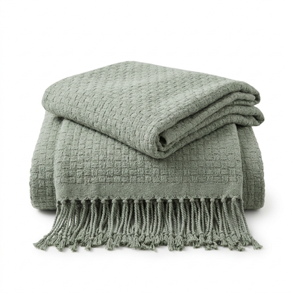 Sage green textured throw with fringed edge on white