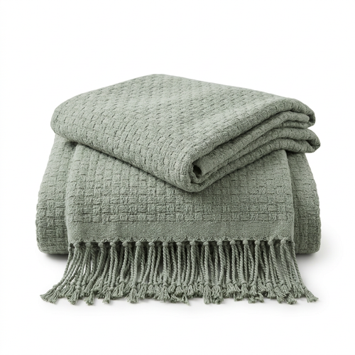 Sage green textured throw with fringed edge on white