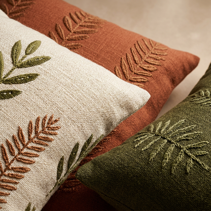 Detail of botanical embroidery and earthy cushion cover colors